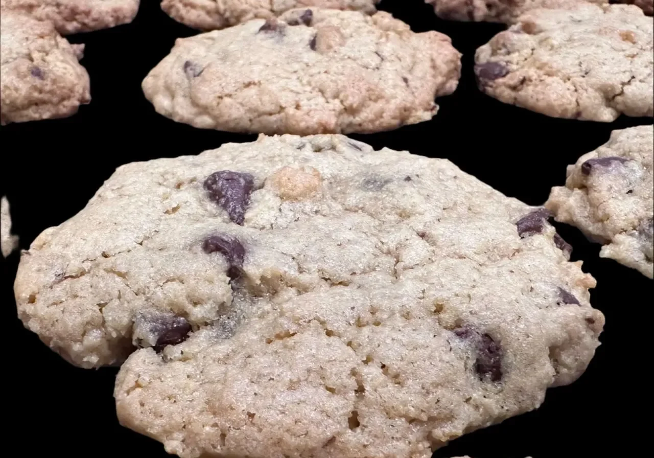 Chocolate chip cookies on a black surface.